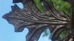 Pictured is a stamped metal oak leaf that has been painted bronze.