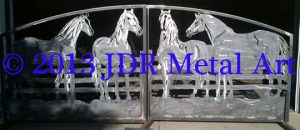 Custom driveway gates designed and plasma cut by JDR Metal Art with equine silhouettes for entrance to Florida ranch & stables.