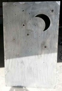 Driveway gate column made from steel sheet with moon and stars cut out by a plasma cutter.