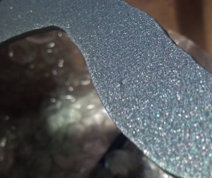 Grey metallic powder flake on metal art headboard.