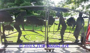 Driveway gates with silhouettes of golfers on a golf course.