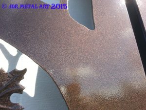 Bronze powder coat on steel driveway gate.