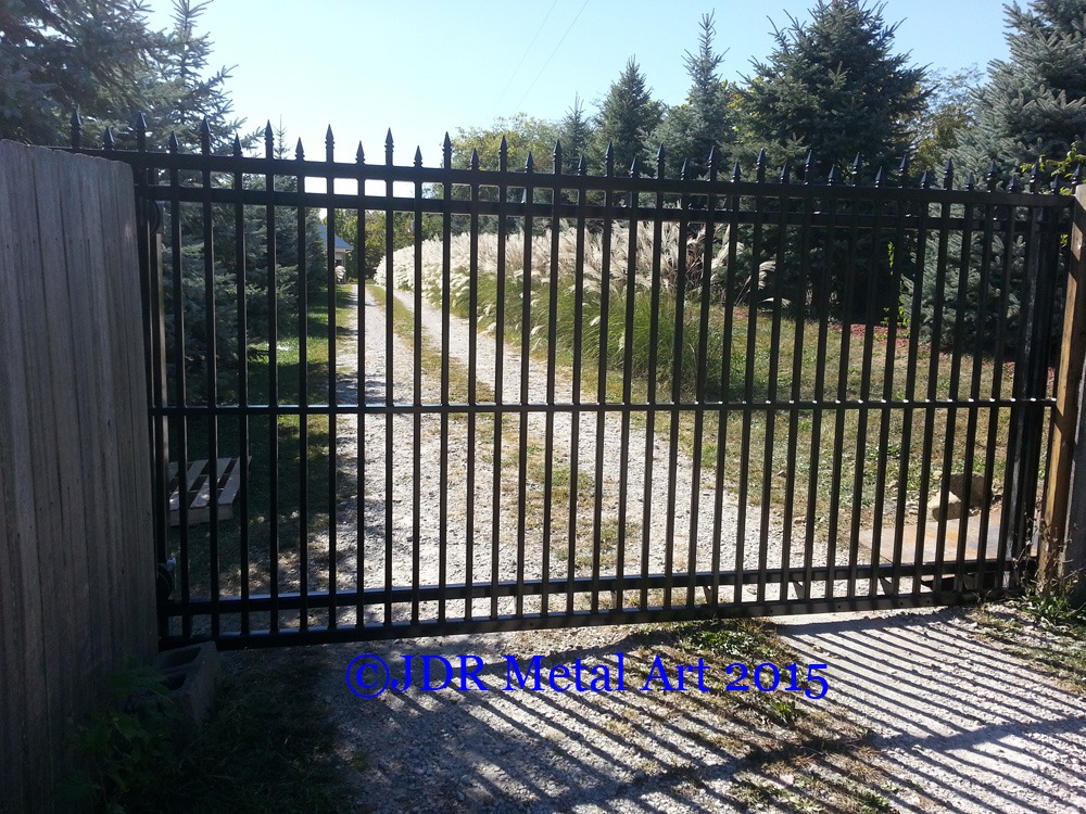 Custom sliding driveway gates with pickets and spears by JDR Metal Art.