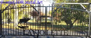 Aluminum driveway gates with pickets, finials, elk silhouettes and name cutouts.