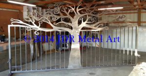 Chattanooga driveway gate made from steel with ornamental tree design.