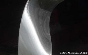 Aluminum sculpture texture from angle grinder.