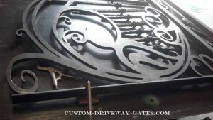 Wrought iron silhouettes custom made for driveway gate with balusters.