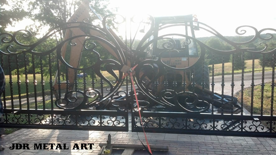 Decorative driveway gate being installed by JDR Metal Art.
