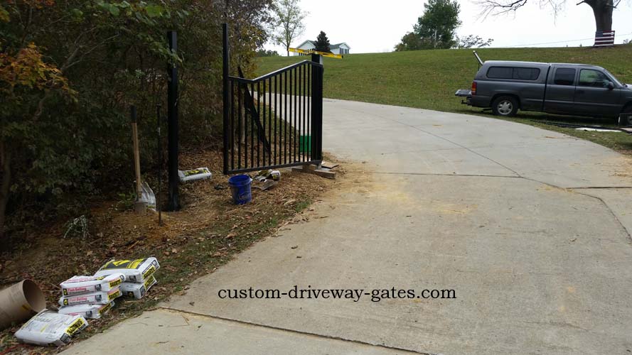 Installing Louisville driveway gates and fence posts.