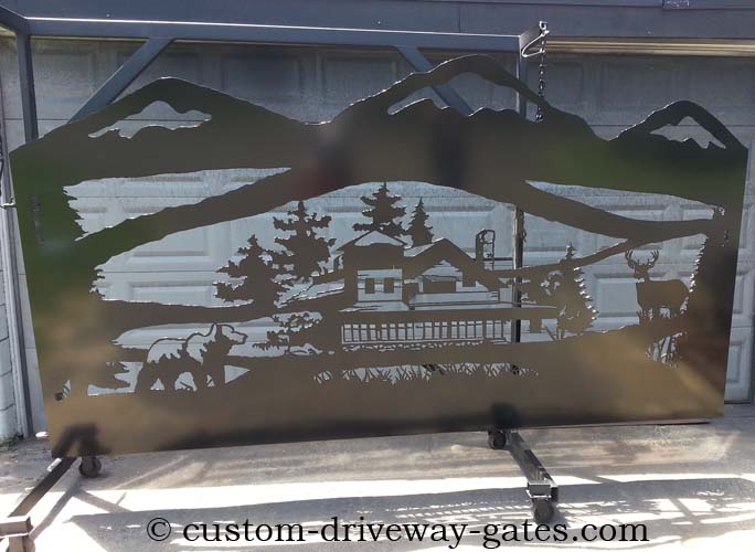 11' single swing driveway gate with metal art lodge cutouts.