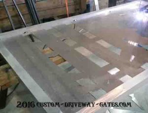 Aluminum driveway gate panel with metal art design being welded in.