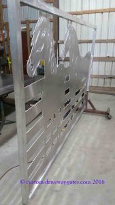 Shiny aluminum driveway gates with horse designs which have been plasma cut by JDR Metal Art.