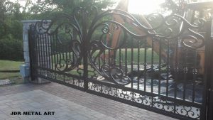 Driveway gates with wrought iron theme for Pennsylvania farm residence.