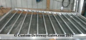 Aluminum drive gate with pickets for fancy gate