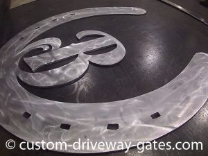 Plasma cut aluminum horse shoe emblem.