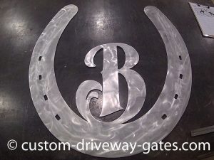 Aluminum horseshoe design cut with plasma cutter by JDR Metal Art.