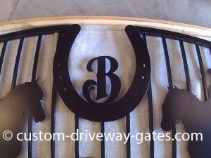 Aluminum driveway gate with horse shoe emblem plasma cut.