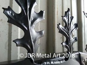 Stamped leaves welded on tree gate