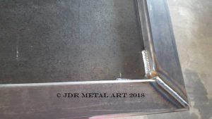 This is a custom metal art gate frame with mig welds.