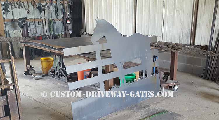 Driveway gate panel with horse design that has been CNC plasma cut from steel sheet.