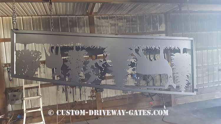 Black powder coated fence panel plasma cut from steel with a 2x2 square tubing frame.