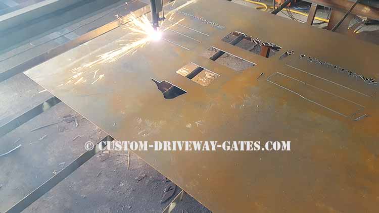 Indianapolis driveway gate panel being plasma cut into metal art horses from an 1/8" thick sheet of 6' tall x 10' wide steel.