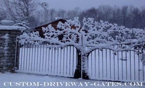 Driveway gate with tree covered in snow by JDR Metal Art unsmushed