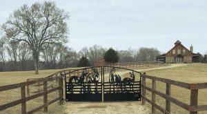Custom farm gates at a farm driveway entrance.