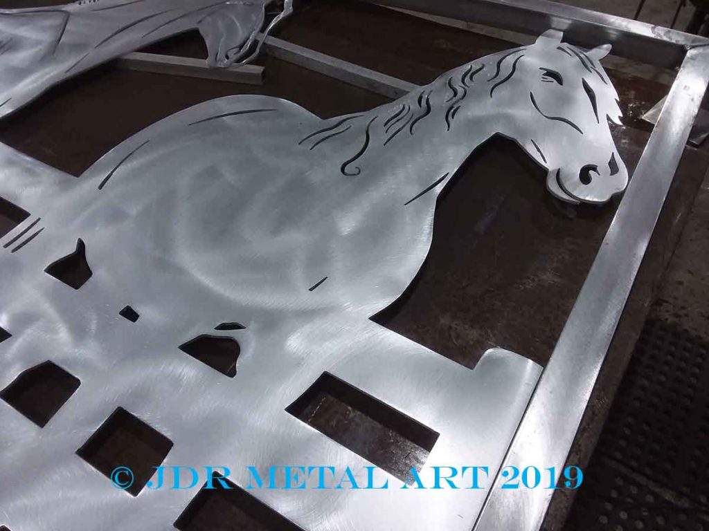 Horse farm driveway gate with plasma cut horse and fence design.
