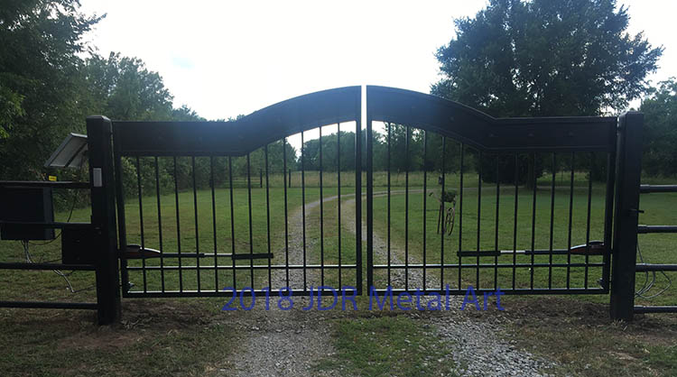 Ranch gates for Tulsa, Oklahoma entrance. Gate has pickets, plasma cut sheet metal and clavos.