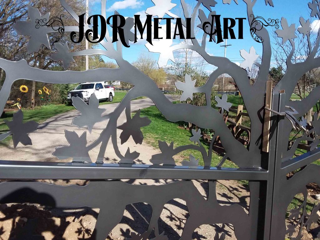 decorative driveway gate with maple tree theme