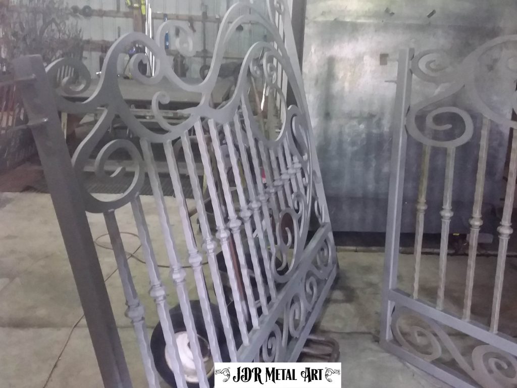Dual swing wrought iron gate.