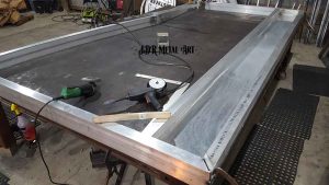 Assembling aluminum sheet and square tubing.