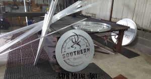 Saw and plasma cut material for custom aluminum gate and sign order.