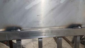 Welded aluminum sheet metal welded to gate frame.