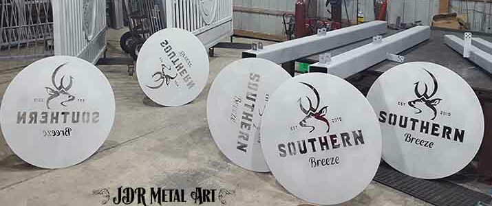 Aluminum gates and signs that have been sandblasted in preparation for powder coating.