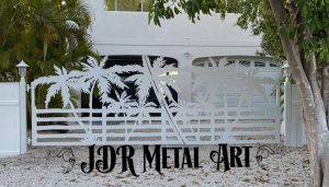 Driveway gate with palm tree design at residence in Marathon, Florida.