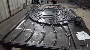 Fabrication of tree of life driveway gate on welding table.