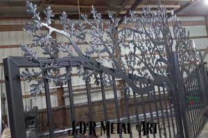 Bronze powder coated iron leaves on tree silhouette welded to gate.