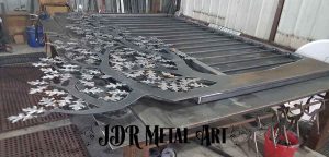Iron gate design laying on welding table.