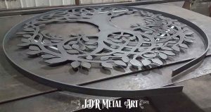 Rolled flat bar and design of tree cut out of 1/4" plate steel.