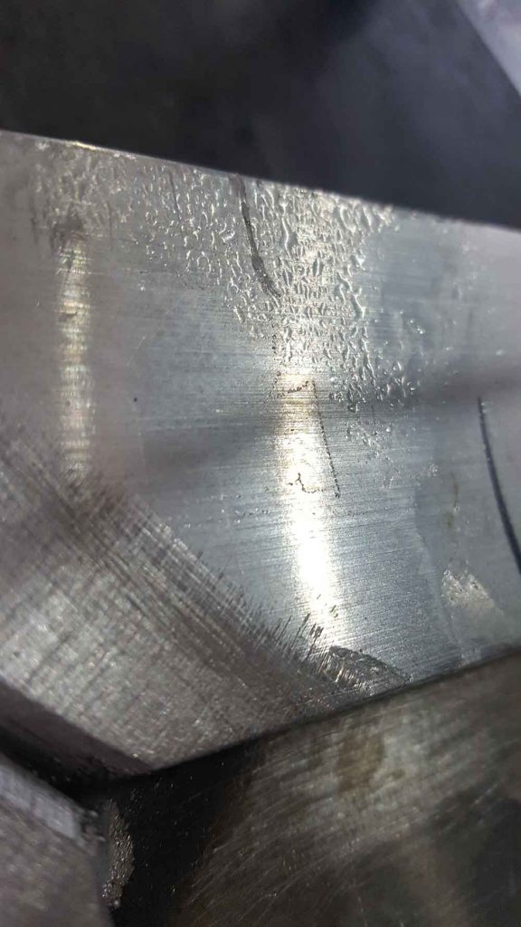 Moisture beading up on heated aluminum while preheating for welding.