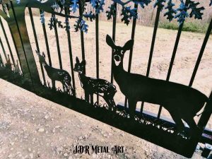 Whitetail deer on driveway gate