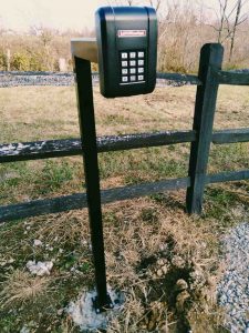 Powder coated keypad stand for driveway gate opener.