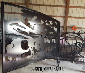 Plasma cut bison made from steel with arched top on swinging gate for Alabama bison farm.