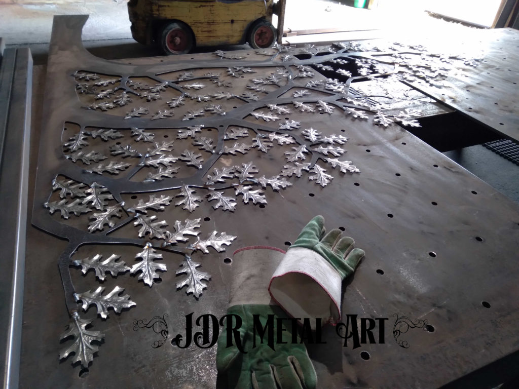 Metal oak tree on steel welding table.