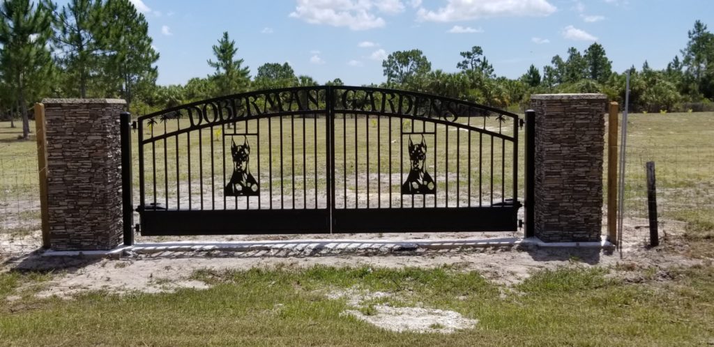 Naples, Florida driveway gates with Doberman metal art silhouettes.