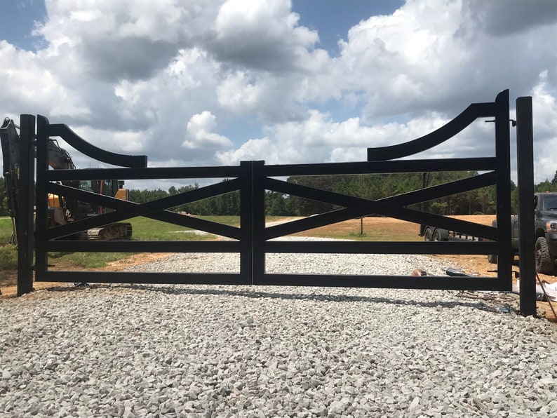 Traditional Ranch Style Driveway Gate with steel and aluminum frame, gate posts and black powder coated finish.