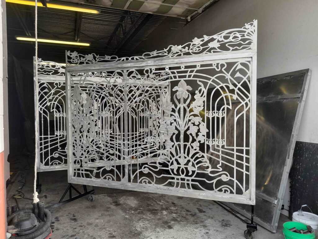 Aluminum driveway gates made from metal with scrollwork design for Estero Florida residential community.
