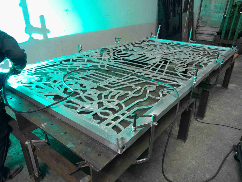 Aluminum driveway gates made from metal with scrollwork design for Estero Florida residential community.